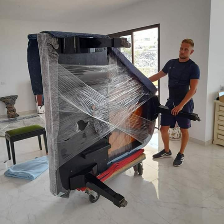 A piano wrapped ready for removal